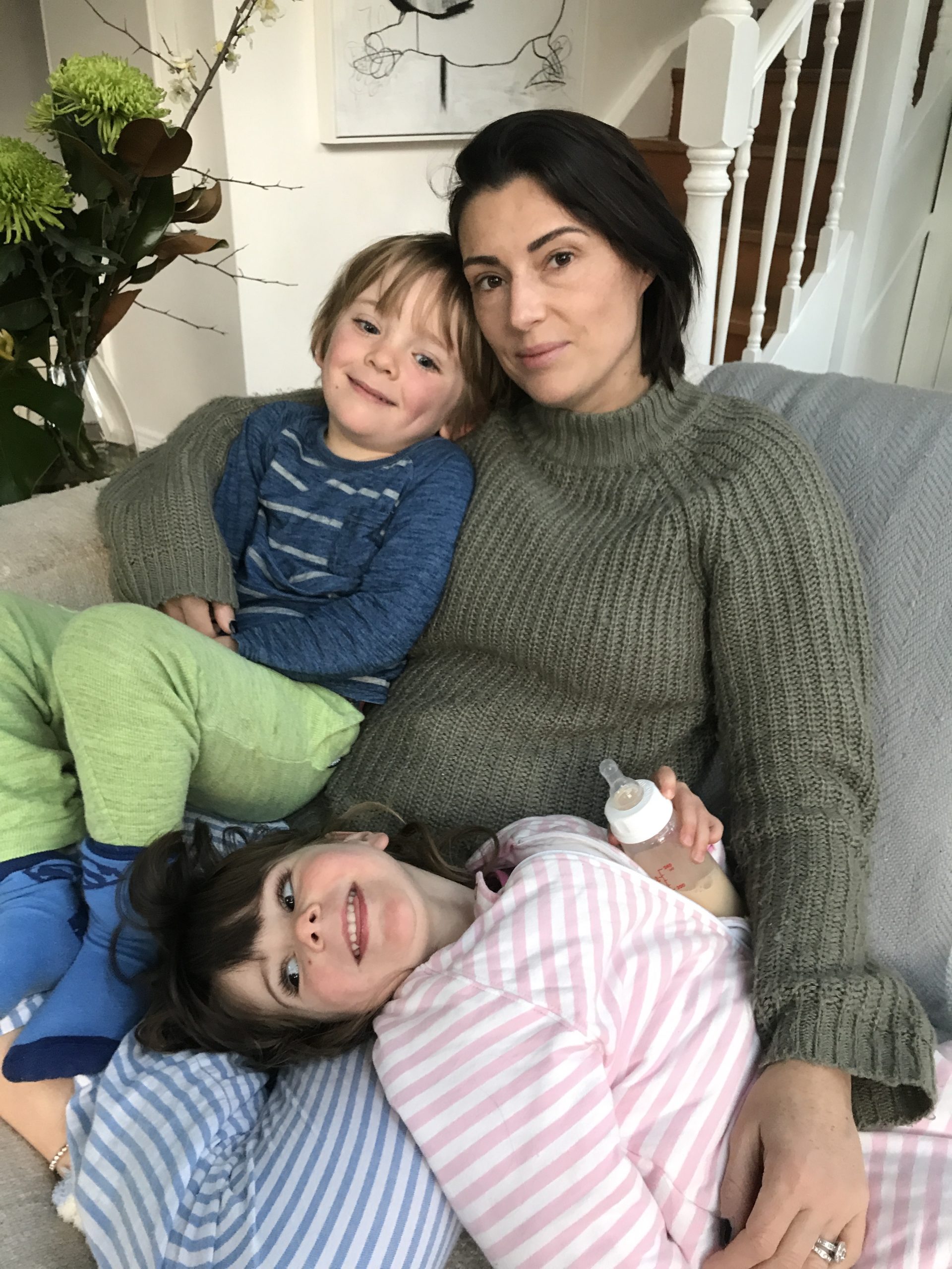 Lou and the kids on the couch having a snuggle