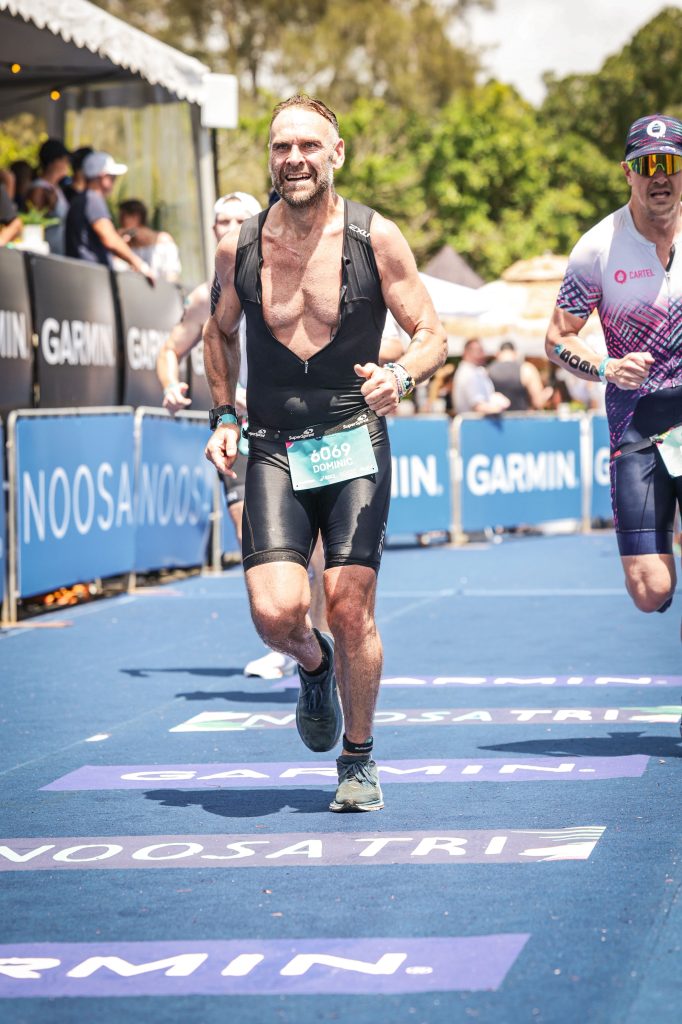 Dominic Byrne finishing the Noosa Triathlon 2024